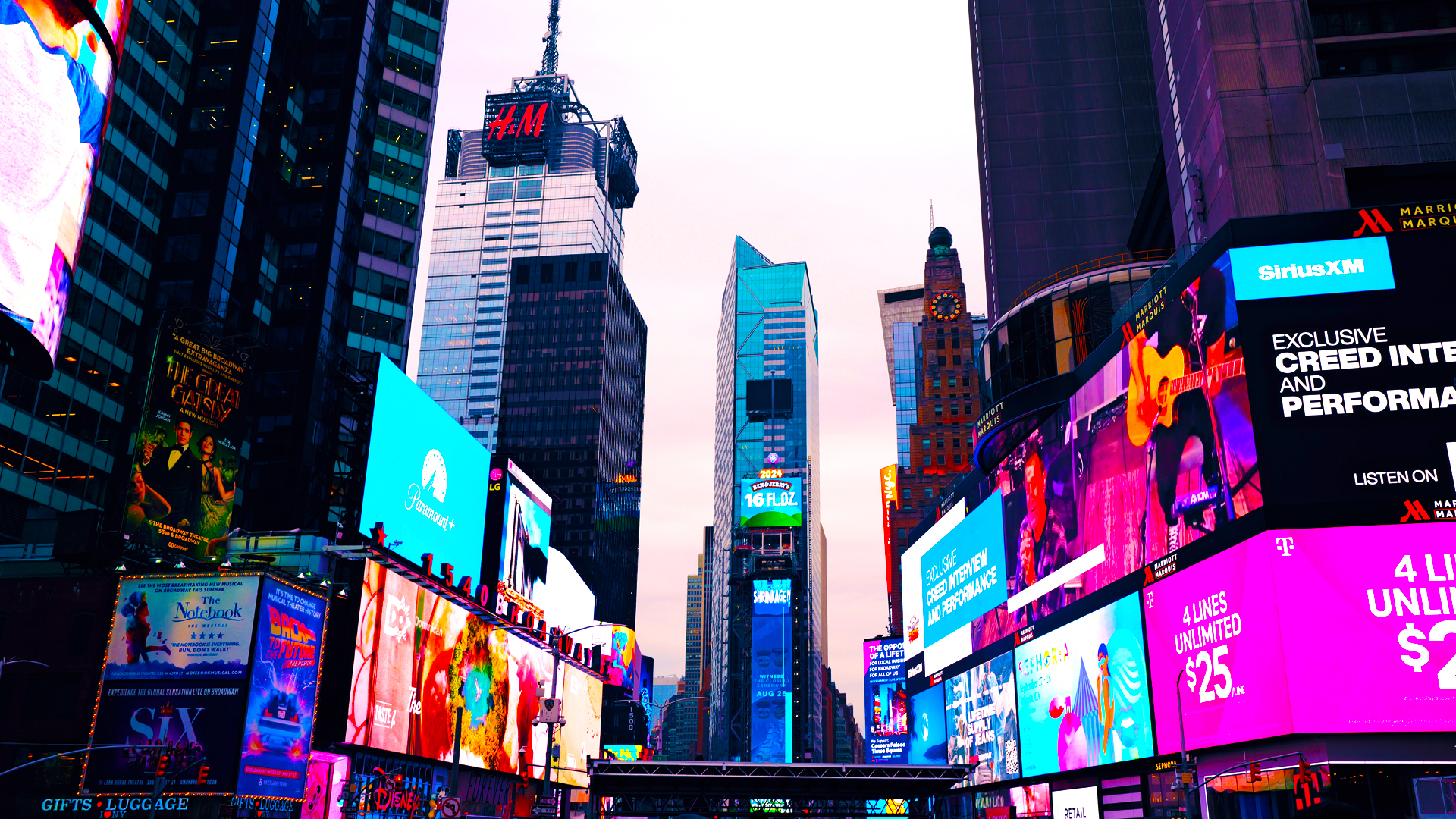 Looking up at the building and digital billboards surrounding Times Square